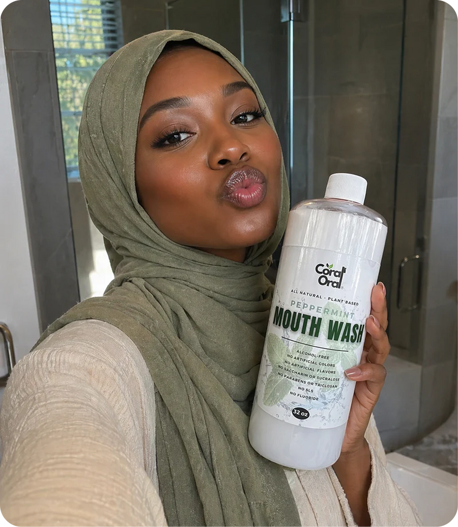 Happy customer holding Coral Oral oral care product